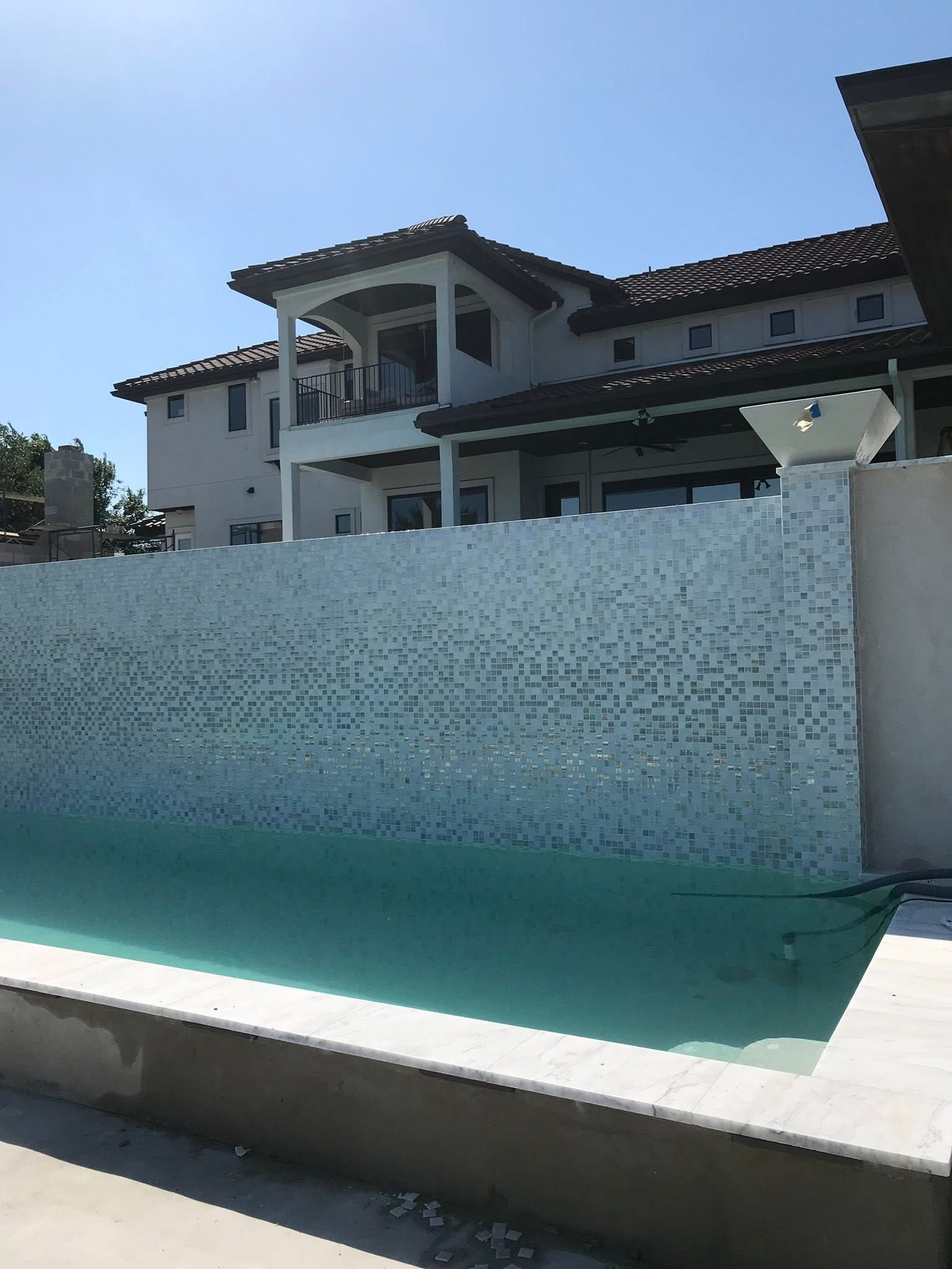 Custom pool with stone hardscape by G&S Construction